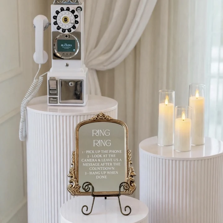 Video Guest Book with three white pedestals and included gold instruction mirror for a Miami wedding rental.