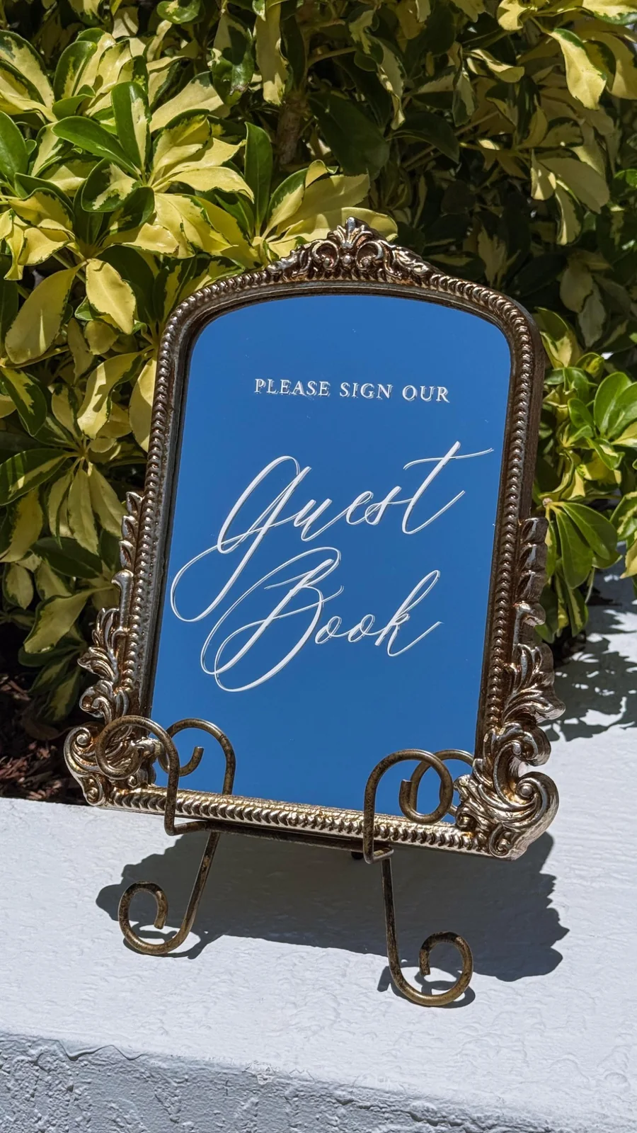 Guest Book Mirror Sign rental for a Miami wedding event, displayed on an antique tabletop mirror with a gold frame by Be Extra Miami.